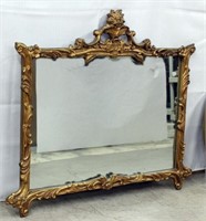 very ornate gilt framed mirror
