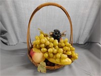 Low high handle basket with wax fruit and plastic