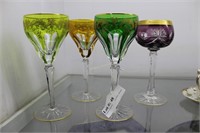 Four cut to clear crystal stemmed goblets with gol