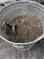 GALVANIZED GARBAGE CAN FULL OF NIGER BIRD SEED MIX