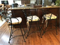 Three wrought iron bar stools with pads