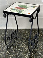 Tile top table, iron base, 4 tiles have flower and