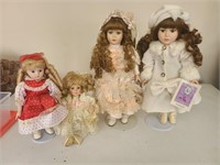 Lot of 4 Porcelain Dolls-1 is a musical doll