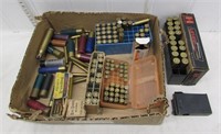 Assorted ammunition, fired brass, and a Mossberg