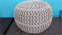 1 Round knit gray pouf.