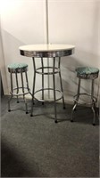 Round chrome bar top table with 2 matching stools