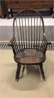 Antique rocking chair with a repair to a spindle