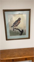 Sign piece of art a hawk sitting on a branch