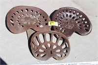 Three vintage implement seats