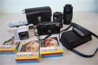 Assorted Cameras, Lens, Flash Cubes & More
