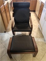 FAUX BROWN LEATHER CHAIR AND OTTOMAN. CHAIR HAS