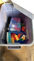 Plastic bin of plastic things and fabric