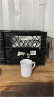 Milk crate of coffee mugs