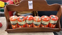 Old spice cans in wooden rack