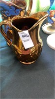2 glass pitchers bronze color