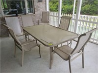 GLASS TOP PATIO TABLE AND 6 CHAIRS