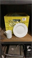 Milk crate of small plates and coffee mugs