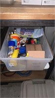Bin of mixed cleaning supplies