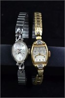 Two 14kt gold wristwatches accented with diamonds: