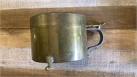 Antique covered brass jug with an iron handle.