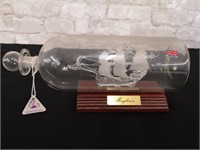 Mayflower glass ship replica in bottle with stand.
