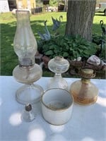 4 oil lamps and small crock