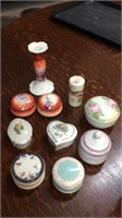 Nine trinket boxes with one candlestick