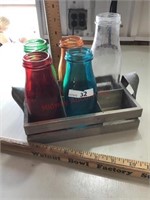 Colored bottles in wood rack