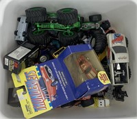 Box of toy monster trucks and toy cars