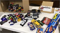 Box of die cast cars and trucks and more