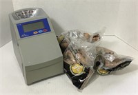 Automatic coin sorting machine and coin wrappers.