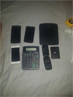 Group of misc broken phones, calculators, and