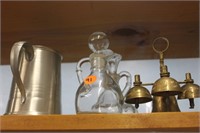 brass bell, perfume bottles, and metal stein