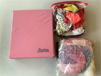 Assorted Barbie clothes with case