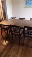 Dining table with 6 music back chairs. 2 leaves