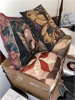 Box of decorative throw pillows.