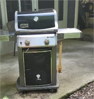 Webber gas grill with cover.