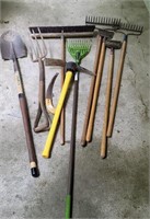 Lot of yard tools. Rakes, broom, shovel etc.