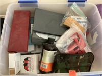 Tote of gun cleaning supplies and scale