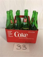 8 Glass 7UP Bottles in Plastic Coke Container