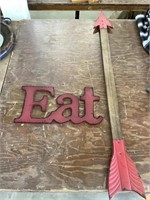 Arrow wall hanging and Eat sign