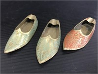 Three brass etched tiny shoe ashtrays