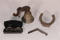 Brass bell, wire rim glasses, horse shoe and knife