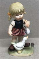 Japan girl with duck and fish figurine