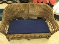 Wicker love seat with cushion. Approx. 54” wide x