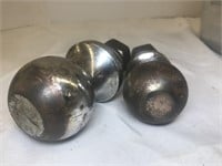 Two trailer hitch balls. One is 2-inch and the