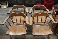 Four wooden dining chairs with arms