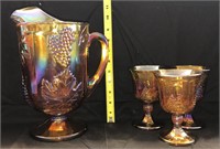 carnvial glass pitcher and 3 goblets