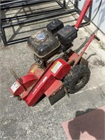 Stump machine with a Honda motor.This machine
