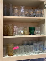 LARGE LOT OF GLASSWARE IN CABINET NOTES MORE